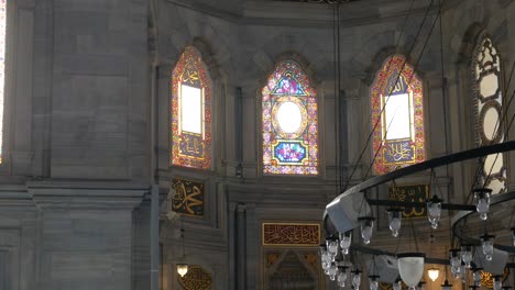 stained glass windows and chandeliers of a mosque