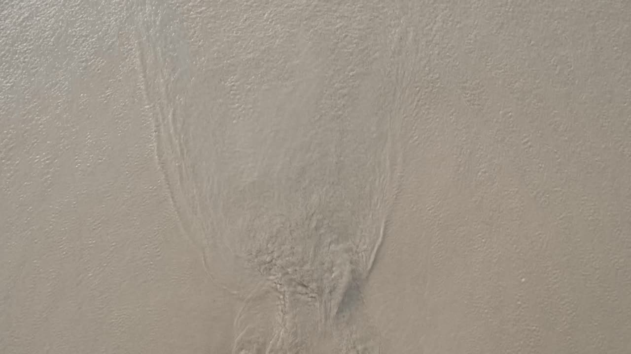 textura superficial de la ola del mar en calma en la playa de arena blanca en el tiempo de sol de verano