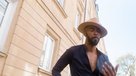 heureux homme afro des caraïbes avec chapeau panama dansant la danse latine seul dans la rue de la vieille ville 5