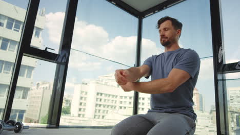 Beard-man-stretching-at-home.-Male-person-doing-warm-up-exercises-indoors.