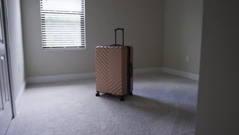 entering an sunny empty room with just a bag of luggage