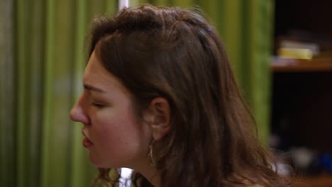 close-up of a woman singing or expressing a strong emotion