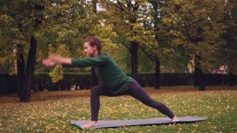 woman practicing yoga in a park during autumn