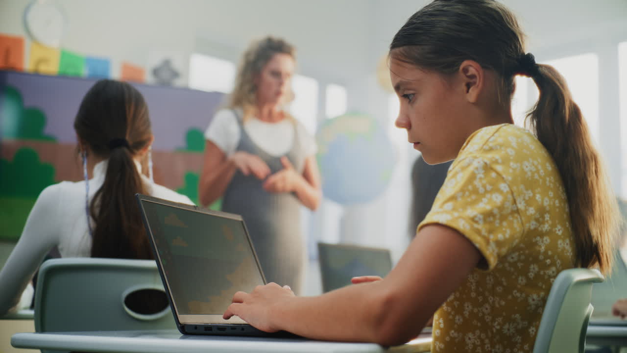 Teacher Educating Young Students Elementary School Children Drawing Pictures on Laptops