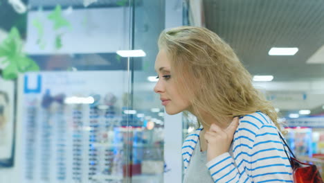 An-Attractive-Woman-With-Shopping-Bags-Dyal-Looking-In-A-Shop-Window-And-Then-Resolutely-Goes-To-The