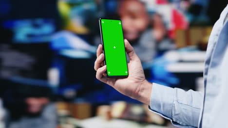 male web user navigates phone with copy space for social media platforms