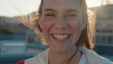 portrait beautiful teenage girl smiling looking happy with wind blowing red hair woman enjoying positive self image in city at sunset