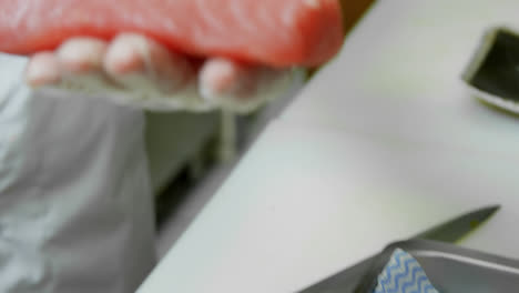 male chef holding sushi in his hand at kitchen 4k