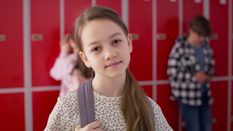 video portrait of smiling girl standing at school