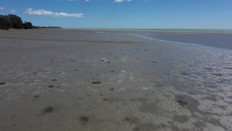 vuelo de drones sobre llanuras de barro hacia el banco de arena en un día soleado con cielo azul