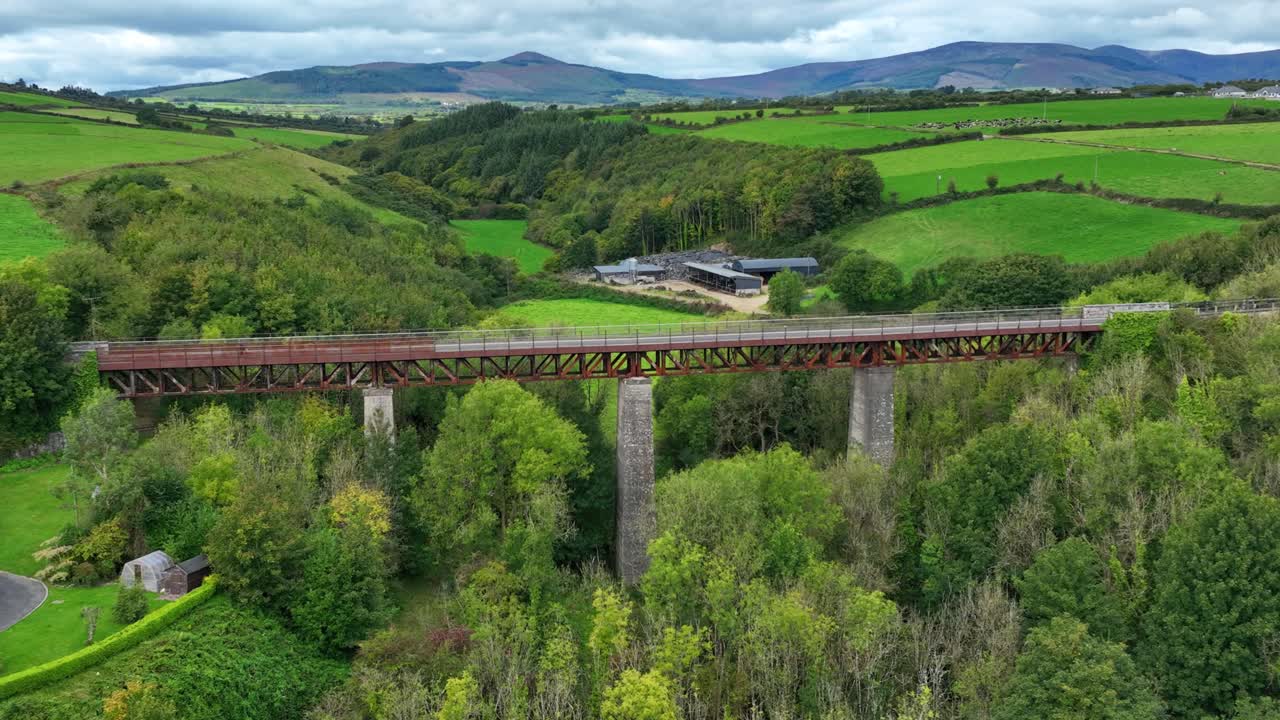 Ireland Epic Locations Waterford Greenway Ballyvoile Viaduct with people cycling and The Comeragh Mountains in the Background