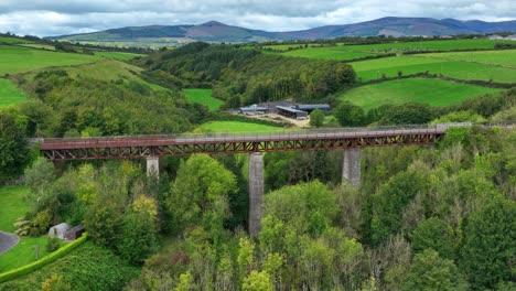 Ireland Epic Locations Waterford Greenway Ballyvoile Viaduct with people cycling and The Comeragh Mountains in the Background