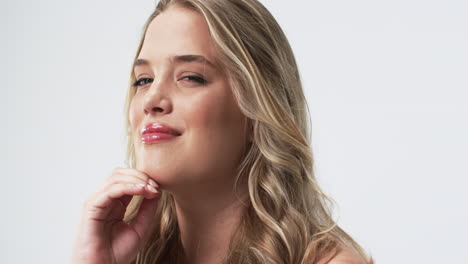 young caucasian plus size woman with long blonde hair and blue eyes posing thoughtfully