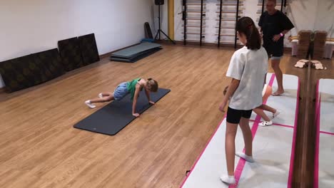 children practicing gymnastics exercises