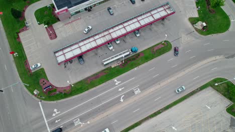 orbiting-aerial-of-a-Tanker-semi-truck-that-unloads-fuel-at-gas-station-in-america