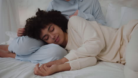 couple in pajamas on bed