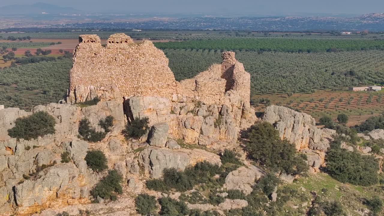 drone orbit in 70mm over the ruins of Dos Hermanas Castle.The flight creates a parallax effect,focusing on the remains of the keep’s walls,with olive groves,farmland,and mountains in the background