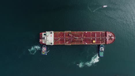 aerial view above boats pushing an empty cargo