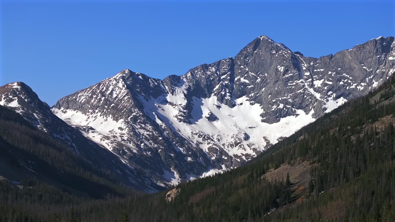 Blanca Peak mount Lindsey Sangre de Cristo Range aerial drone Colorado Rocky Mountains San Isabel National Forest Lily Lake trail sunny morning blue skies spring summer snow fields parallax right