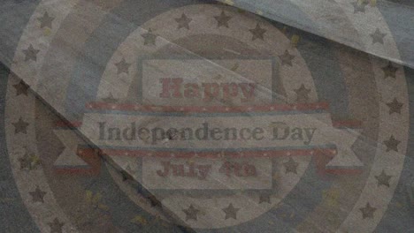 Animation-of-happy-independence-day-text-over-start-and-circular-stripes-of-flag-of-america-on-wood