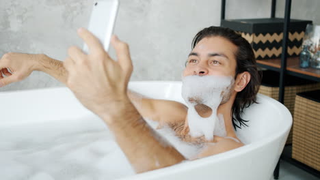 man taking a selfie in a bath tub