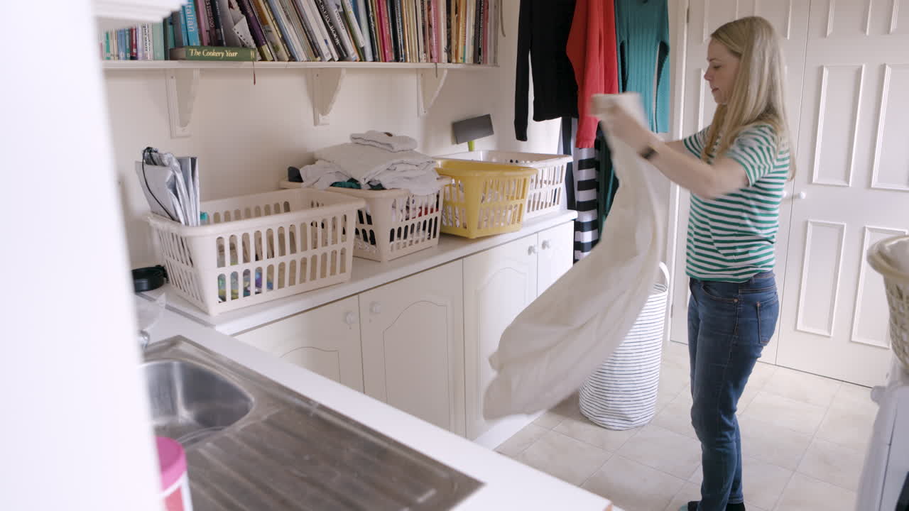 Woman doing laundry in a bright laundry room