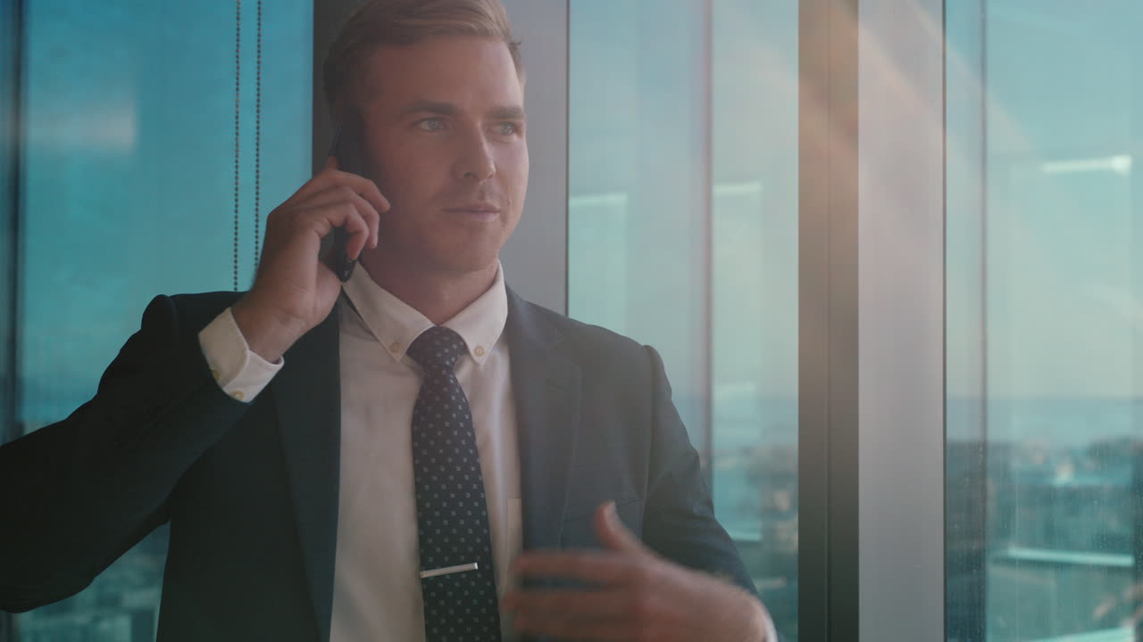 businessman using smartphone chatting to client financial advisor negotiating business deal corporate sales executive sharing expert advice having phone call in office looking out window