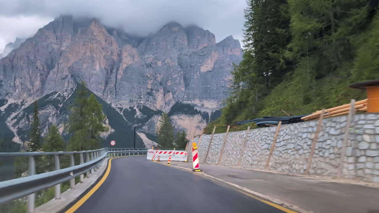 Driving on new road on construction site in Italian Dolomites, pov