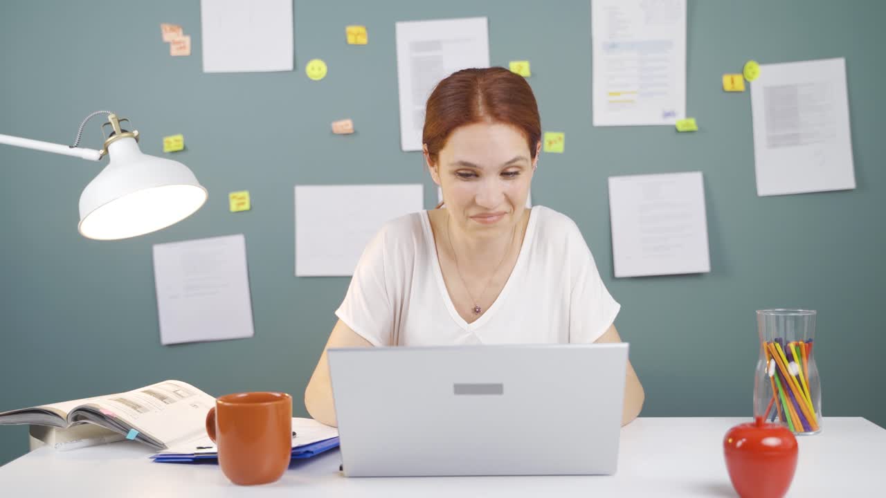 Satisfied with what she sees on the laptop, the woman nods.