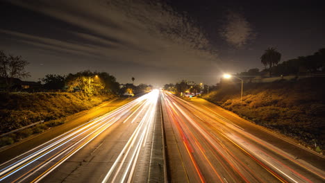 time lapse of busy night traffic across freeway in los angeles