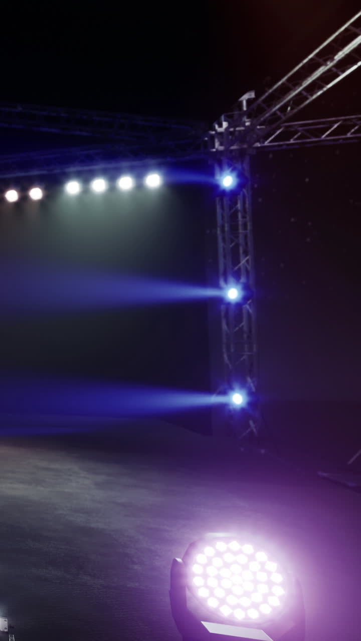 Stage lights shine brightly in a dark performance space at night