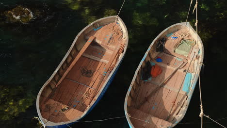 two wooden fishing boats in the water