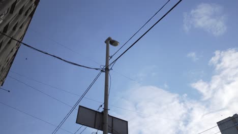 cityscape view with power lines and lamp post