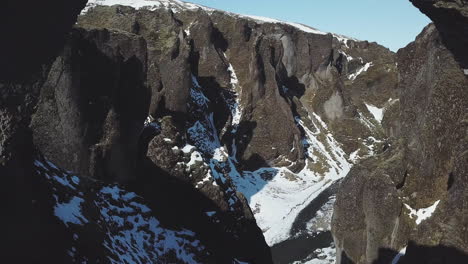 Aerial-View-Drone-Flying-in-beautiful-scenery-between-mountains-in-cold-Iceland