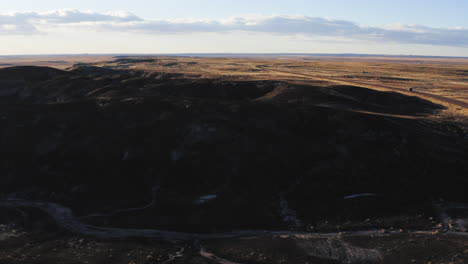 aerial landscape of arizona desert badlands with road, drone flying forward shot