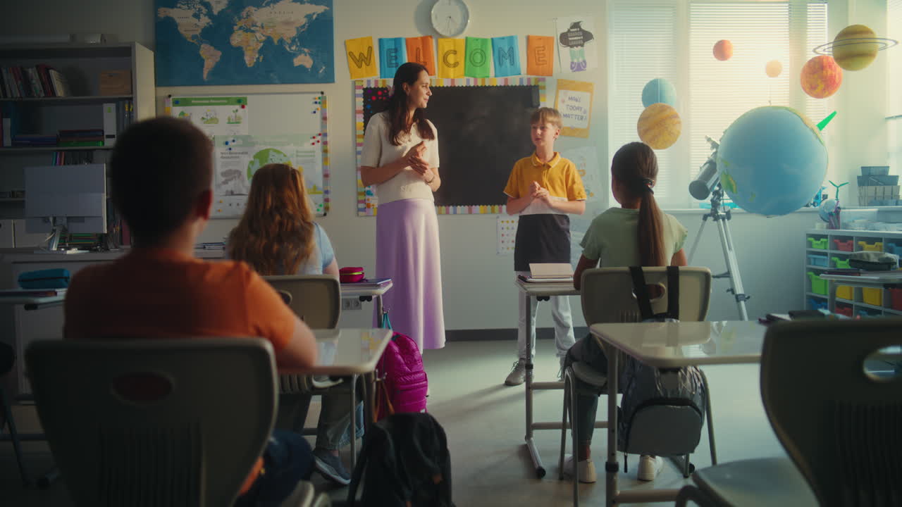 Elementary School Student Speaking About Energy Sources in Front of Classroom
