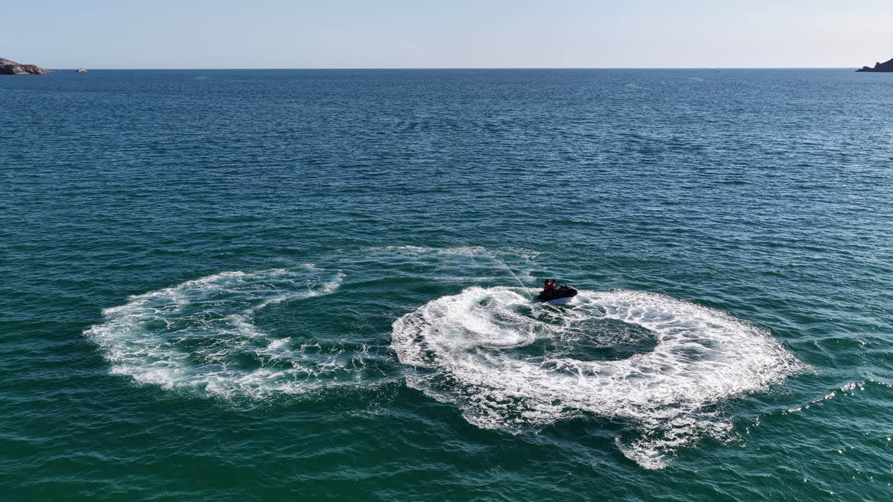 Jet ski sails across the sea in a circle at high speed