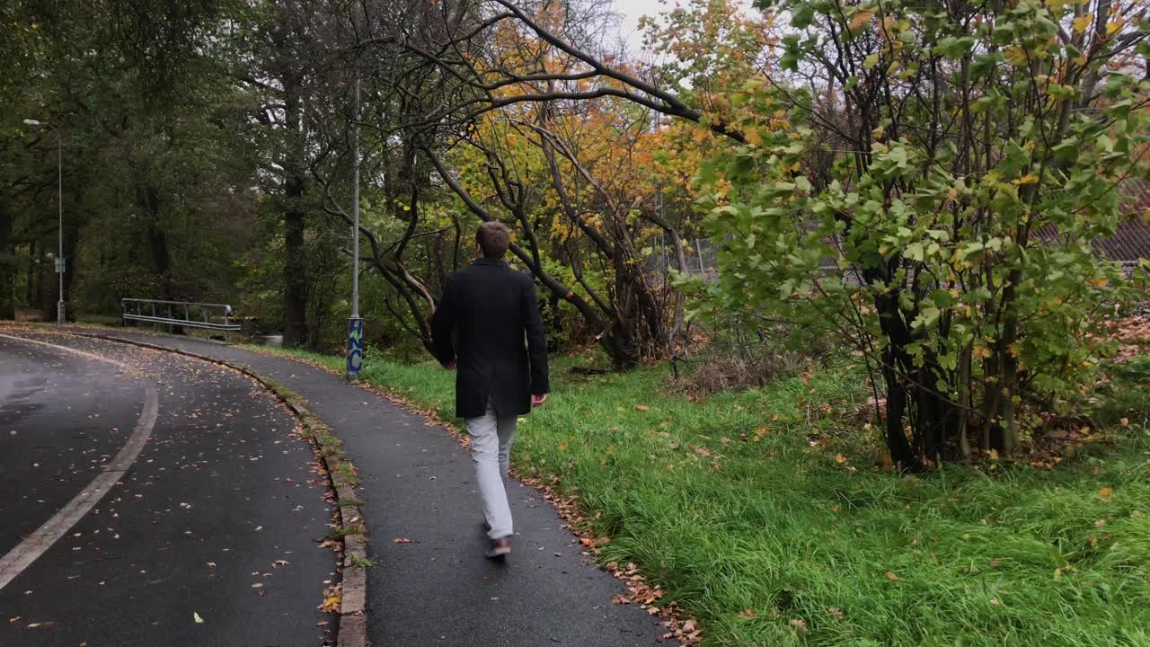 A man walking outside in autumn
