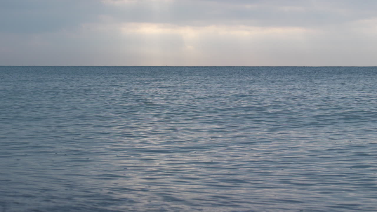 바다의 파도 질감은 표면에 반사된 새벽 빛의 부드러운 빛처럼 매혹적인 고요함으로 반짝였습니다.