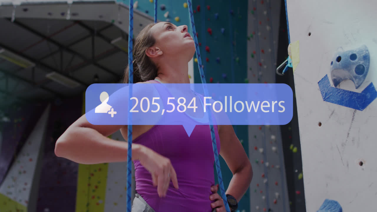 Animation of media icon over caucasian woman on climbing wall