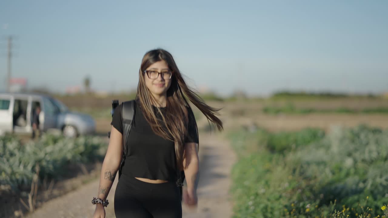Woman Hiking in a Countryside Path