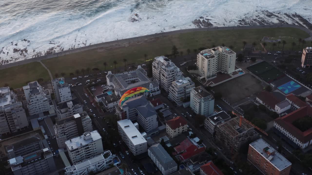 Aerial view of paraglider flying above city of Cape Town, South Africa. Adrenaline, extreme sport sand adventure concept.