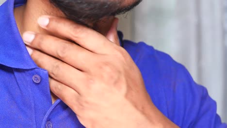 hombre tocando su dolor de garganta