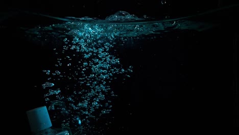 underwater shot of bottle of perfume