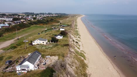 hemsby seaside village norfolk england houses on edge of cliff , in danger aerial footage 4k