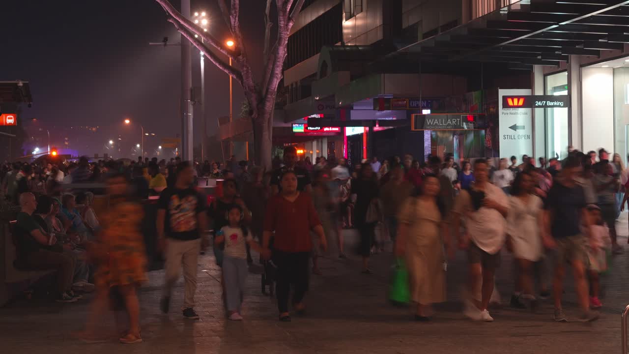 Fast motion time-lapse shot of the foot traffic in Queen Street Mall after Riverfire fireworks, a shopping and dinning precinct at night, showcasing the influx of population in Brisbane city.