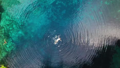 Straight-Down-Aerial-Of-A-Woman-Swimming-In-A-Beautiful-Lake-Or-Pond-On-A-Tropical-Island-Vanuatu