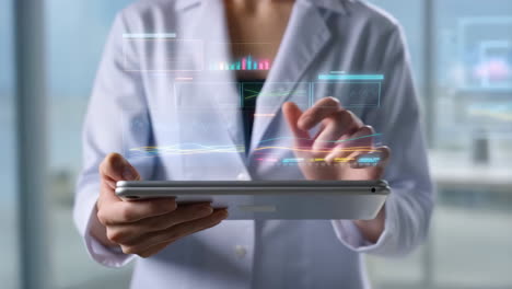 healthcare professional interacting with futuristic digital data on tablet