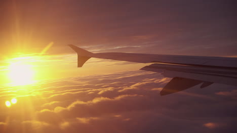 sunrise above the clouds viewing the plane wing