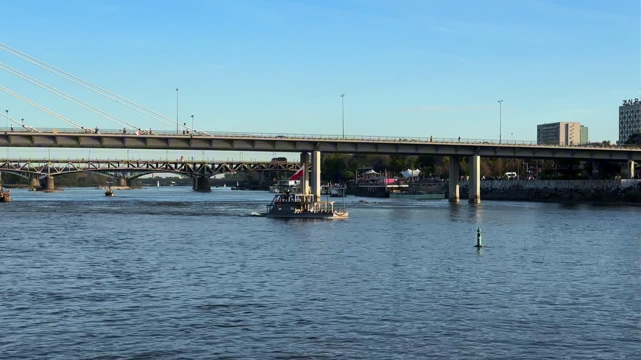 A small boat is going down the river
